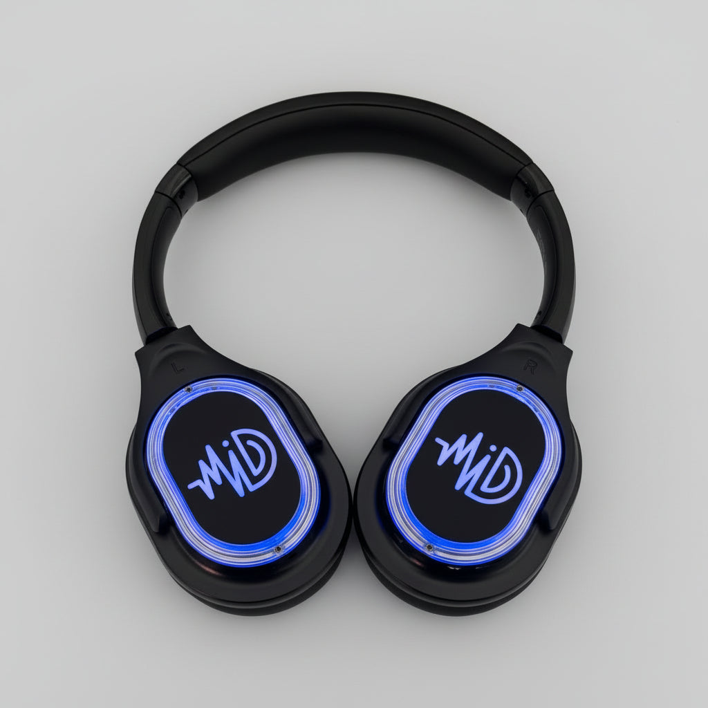 Black headphones with blue LED display on a cardboard box against a concrete floor background